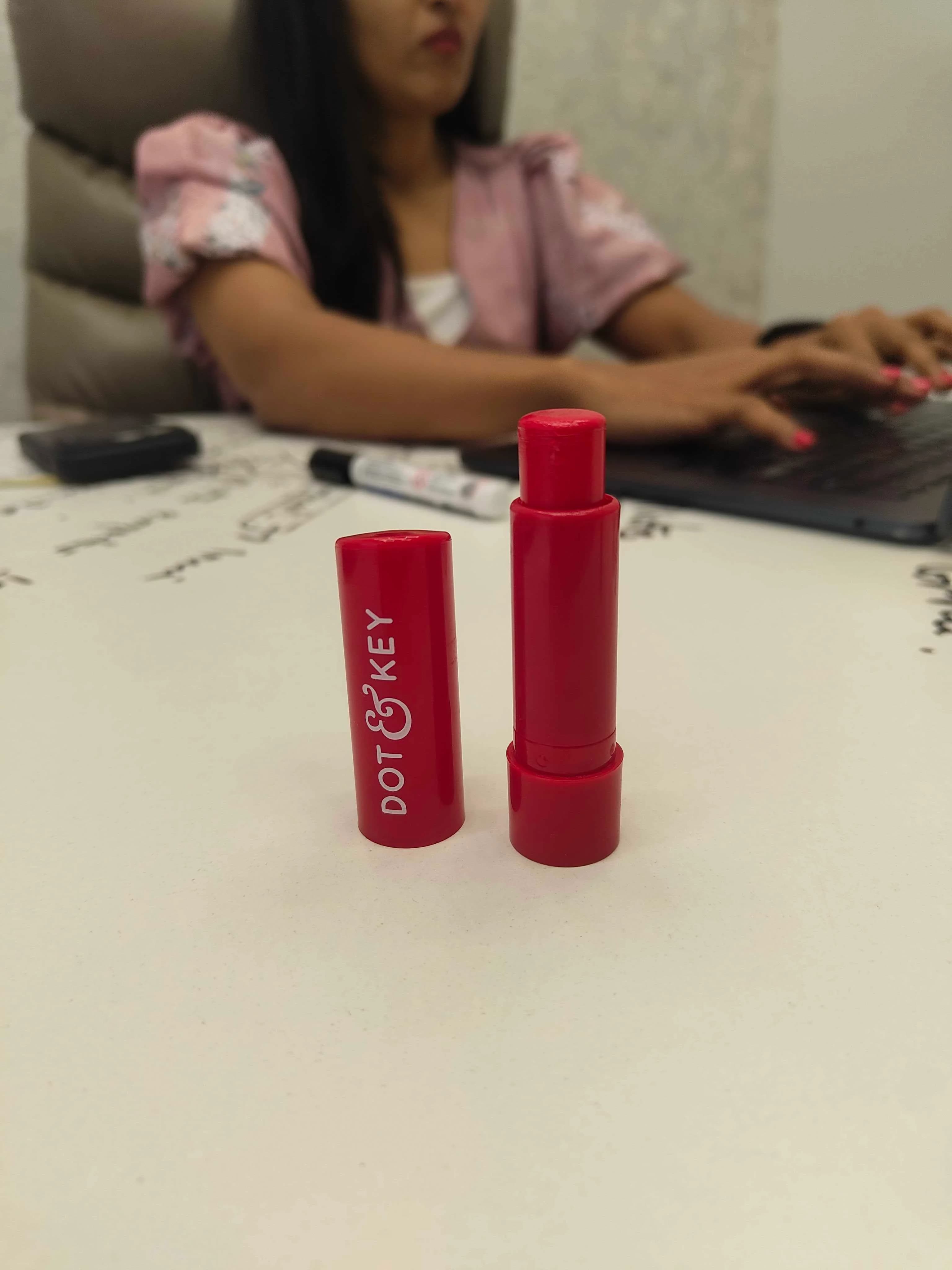 Camera viewfinder capturing a Dot & Key strawberry red lip balm